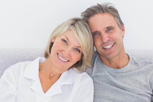 Couple smiling after getting dental bridges in Beachwood, OH